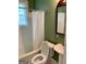Bathroom features shower and bathtub combo, pedestal sink, and window at 242 12Th Ne St # 1A, Atlanta, GA 30309