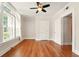 Bedroom featuring hardwood floors, large windows, and a ceiling fan at 242 12Th Ne St # 1A, Atlanta, GA 30309