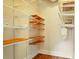 Walk-in closet featuring custom shelving with wooden accents and hardwood floors at 242 12Th Ne St # 1A, Atlanta, GA 30309