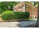 Brick building with lush greenery in the background at 242 12Th Ne St # 1A, Atlanta, GA 30309