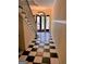Inviting foyer features black and white tile flooring and grand staircase with glass paneled entry doors at 242 12Th Ne St # 1A, Atlanta, GA 30309