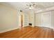 Sun-filled living room features hardwood floors, built-in shelving, and a ceiling fan at 242 12Th Ne St # 1A, Atlanta, GA 30309