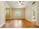 Spacious living room featuring gleaming hardwood floors, a ceiling fan, and natural light from large windows at 242 12Th Ne St # 1A, Atlanta, GA 30309