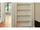 Built-in shelving unit with storage next to a light-filled living room at 242 12Th Ne St # 1A, Atlanta, GA 30309