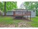 Exterior view of a house showing a wooden deck overlooking the grassy backyard at 3963 Holland Ct, Douglasville, GA 30135