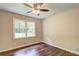 This bedroom features a window overlooking the yard and hardwood floors at 3963 Holland Ct, Douglasville, GA 30135