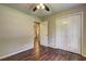 A bedroom with tan walls, hardwood floors, and white closet doors at 3963 Holland Ct, Douglasville, GA 30135