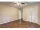 A bedroom with tan walls, hardwood floors, and white closet at 3963 Holland Ct, Douglasville, GA 30135