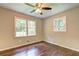 This bedroom is bright with windows and hard wood flooring at 3963 Holland Ct, Douglasville, GA 30135