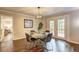 Elegant dining room with a modern light fixture, wood floors and access to the outdoor deck at 3963 Holland Ct, Douglasville, GA 30135