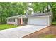 View of an updated home with a red door and attached garage, complemented by a well-maintained lawn at 3963 Holland Ct, Douglasville, GA 30135