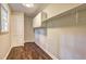 Laundry room features neutral walls, hardwood floors, and storage cabinets at 3963 Holland Ct, Douglasville, GA 30135