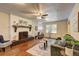 Spacious living room features a brick fireplace, hardwood floors, and natural light from the window at 3963 Holland Ct, Douglasville, GA 30135