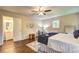 Well-lit main bedroom with hardwood flooring, ceiling fan, and neutral paint colors at 3963 Holland Ct, Douglasville, GA 30135
