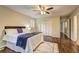 Bedroom showcasing wood floors, a ceiling fan, and an attached walk-in closet at 3963 Holland Ct, Douglasville, GA 30135