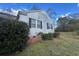 Side view of a well-kept bungalow featuring tidy landscaping and a small yard at 5111 Newark Ave, Clarkdale, GA 30111