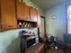 Kitchen with wood cabinets and a microwave, offering practical storage and cooking space at 5111 Newark Ave, Clarkdale, GA 30111