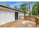 Covered back deck that leads to an exterior door on a painted brick home with beautiful backyard at 6932 Eunice Dr, Riverdale, GA 30274
