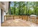 Back deck, perfect for enjoying the wooded scenery and outdoor living, is constructed with railings and stairs at 6932 Eunice Dr, Riverdale, GA 30274