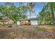 Exterior view of a home's back yard featuring a deck, a backyard, and a fire pit at 6932 Eunice Dr, Riverdale, GA 30274