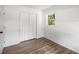 Bedroom featuring hardwood floors and closet with multiple doors at 6932 Eunice Dr, Riverdale, GA 30274