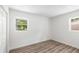 Bedroom featuring hardwood floors, a closet, and two windows with natural light at 6932 Eunice Dr, Riverdale, GA 30274