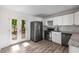 Inviting kitchen area with stainless steel appliances, bright cabinets, and easy access to the back deck at 6932 Eunice Dr, Riverdale, GA 30274