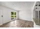 Bright, open-concept living room with new flooring, fresh paint, and a large window for natural light at 6932 Eunice Dr, Riverdale, GA 30274