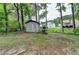 View of backyard featuring storage shed, mature trees, and well-maintained lawn at 2121 Crescentview Dr, Lawrenceville, GA 30044
