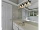 Bright bathroom features a tub, mirrored vanity with modern lighting, and two doors at 2121 Crescentview Dr, Lawrenceville, GA 30044