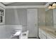 This spacious bathroom has a large tub, white door and ample space for modern comfort at 2121 Crescentview Dr, Lawrenceville, GA 30044