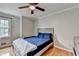 Cozy bedroom features hardwood floors, a ceiling fan, and ample natural light at 2121 Crescentview Dr, Lawrenceville, GA 30044