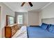 Bedroom featuring a bed with wooden floors, a dresser, and a bright window at 2121 Crescentview Dr, Lawrenceville, GA 30044