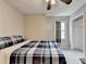 Bright bedroom featuring neutral walls, ceiling fan and a window with gray curtain at 2121 Crescentview Dr, Lawrenceville, GA 30044