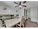 Bright dining area with a ceiling fan, wooden table and chairs, and view to front room at 2121 Crescentview Dr, Lawrenceville, GA 30044