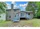 Exterior back view of home with deck, chimney and blue-painted stairs at 2121 Crescentview Dr, Lawrenceville, GA 30044