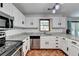Well-lit kitchen with stainless steel appliances and white cabinets at 2121 Crescentview Dr, Lawrenceville, GA 30044