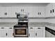 Bright kitchen features white cabinets, stainless steel appliances, and granite countertops at 2121 Crescentview Dr, Lawrenceville, GA 30044