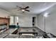 Cozy living room with a fireplace, ceiling fan and a leather couch at 2121 Crescentview Dr, Lawrenceville, GA 30044