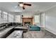 Open-plan living room with a brick fireplace and a dark leather couch with turquoise lounge at 2121 Crescentview Dr, Lawrenceville, GA 30044