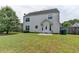Back exterior view featuring a well-maintained yard and two-story home architecture at 2355 Glen Chase Ln, Lawrenceville, GA 30044
