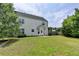 A well-maintained backyard with green grass, shaded by mature trees and a fence, complements the home's exterior at 2355 Glen Chase Ln, Lawrenceville, GA 30044