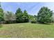 Spacious backyard featuring a lush lawn, mature trees, and a serene, private setting at 2355 Glen Chase Ln, Lawrenceville, GA 30044