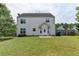 A well-manicured backyard featuring a lush lawn and a charming two-story home with white siding and ample natural light at 2355 Glen Chase Ln, Lawrenceville, GA 30044