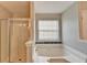 Relaxing bathroom showcasing a soaking tub, separate shower, and window for natural light at 2355 Glen Chase Ln, Lawrenceville, GA 30044