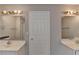 Bright bathroom featuring dual vanities, modern fixtures, and a clean, neutral color palette at 2355 Glen Chase Ln, Lawrenceville, GA 30044