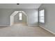 Spacious bedroom with neutral carpet, natural light, and a charming dormer nook at 2355 Glen Chase Ln, Lawrenceville, GA 30044