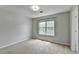 A carpeted bedroom has neutral walls and a window letting in natural light at 2355 Glen Chase Ln, Lawrenceville, GA 30044