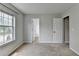 Bright carpeted bedroom with neutral walls, and an open closet at 2355 Glen Chase Ln, Lawrenceville, GA 30044