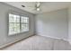 Bedroom with neutral paint, carpet, and large window at 2355 Glen Chase Ln, Lawrenceville, GA 30044